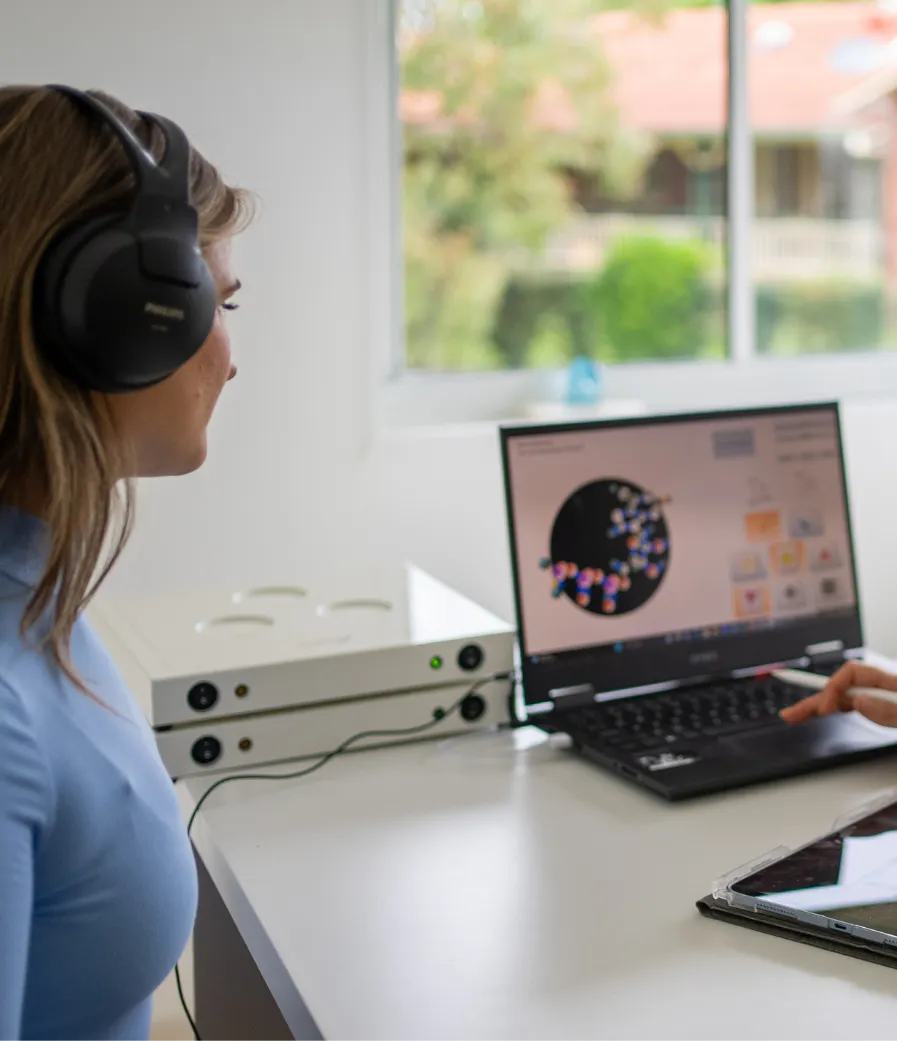 Patient wearing headphones during a qEEG neurotherapy session