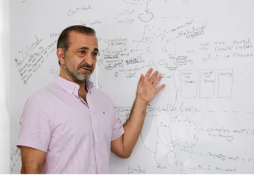 Practitioner explaining a whole-person health approach at the whiteboard